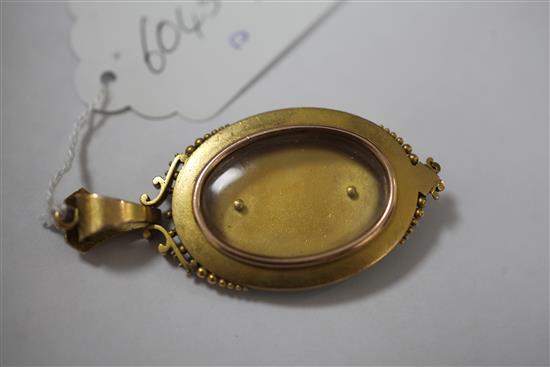 A Victorian Etruscan style gold and turquoise set oval pendant locket, 2.75in inc. bale.
